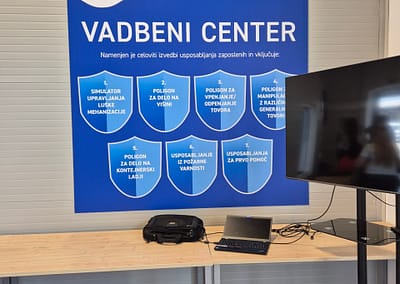 Frontal view of a modern training center building with large glass panels, main entrance, and clean architectural lines.